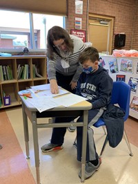 Teacher helping student