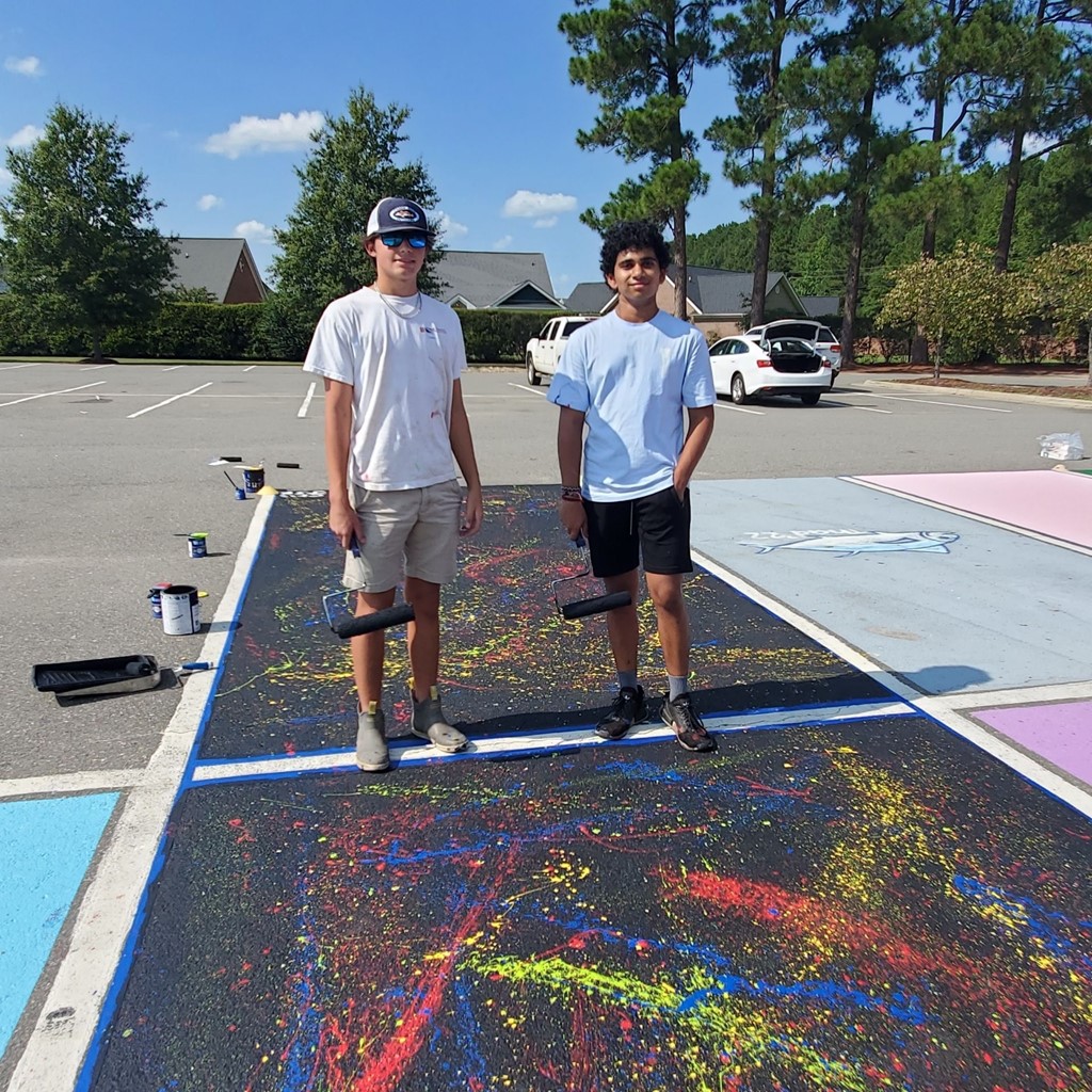 Senior boys painting parking spots