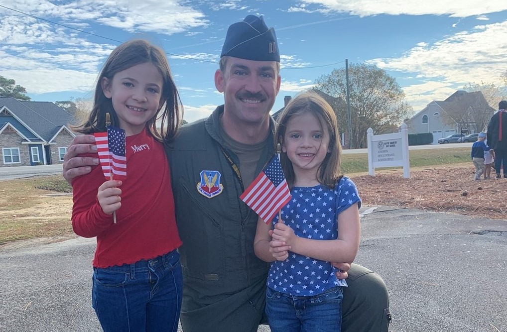 Dad posing with his children for veterans day celebration