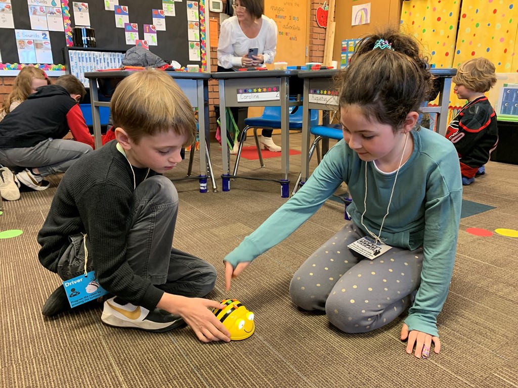 2nd graders playing with Bee Bots