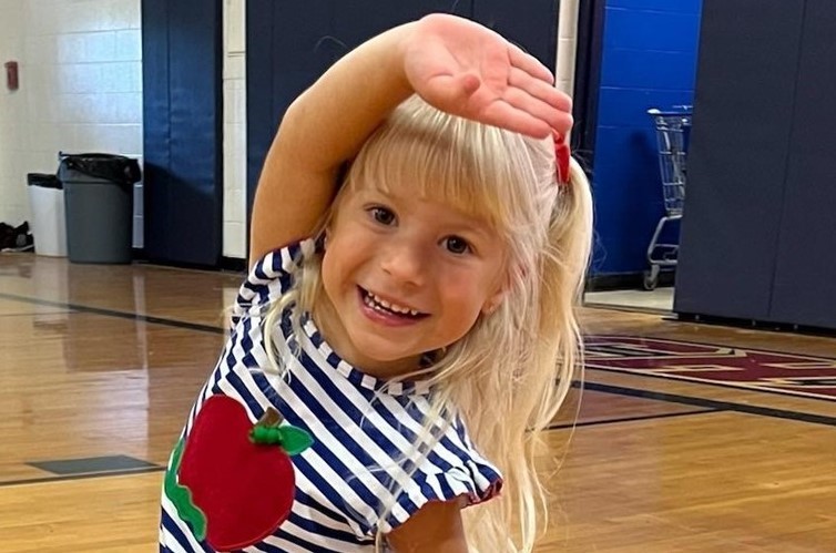 3K student strectching during PE