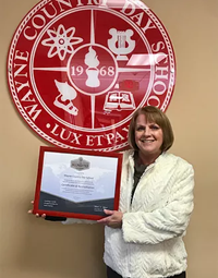 Teacher holding a plaque